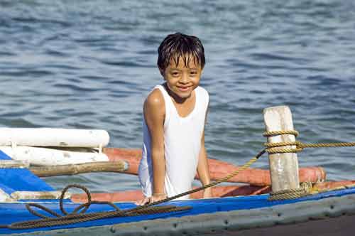 boy on a boat-AsiaPhotoStock