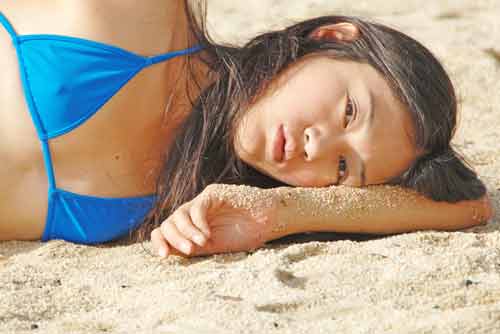 laying on the sand-AsiaPhotoStock