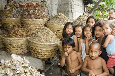 children with dried fish-AsiaPhotoStock