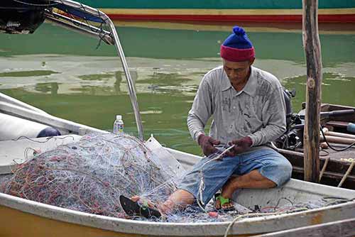 mending fishing nets-AsiaPhotoStock