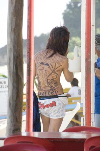 tattooed man white beach-AsiaPhotoStock