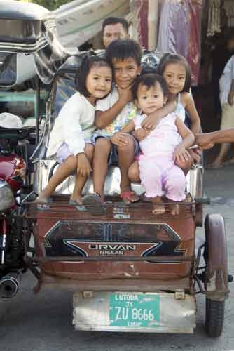 children on tricycle-AsiaPhotoStock