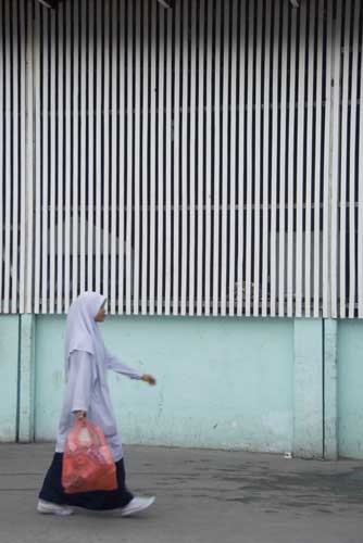 walk by mosque wall-AsiaPhotoStock